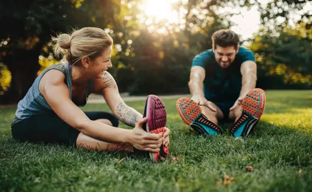 Photo of Young caucasian couple exercising in park