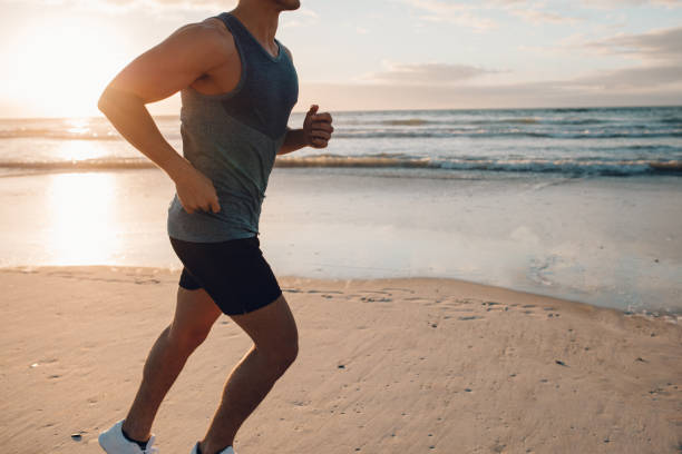 istock Young man running along the beach in morning 640351750