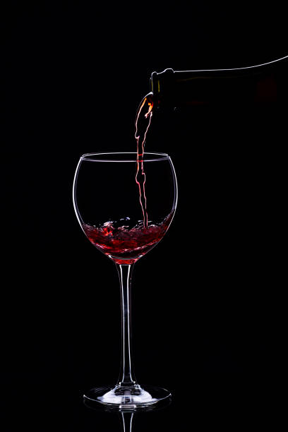 istock Wine glasses with wine bottle on a black background, minimalism, 640352748