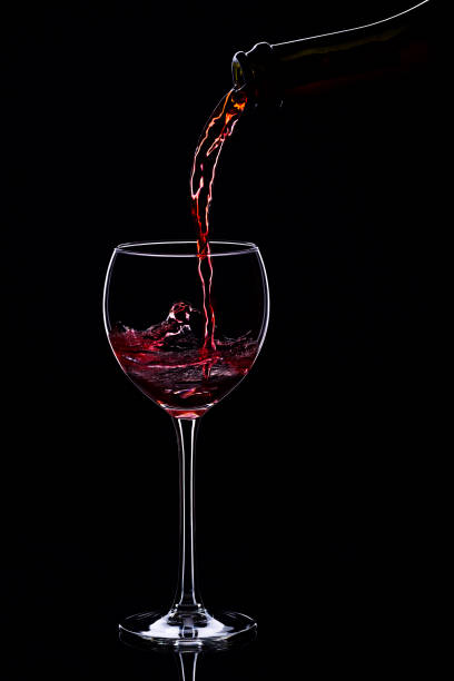 istock Wine glasses with wine bottle on a black background, minimalism, 640352804