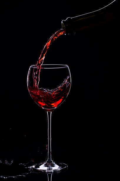 istock Wine glasses with wine bottle on a black background, minimalism, 640352832