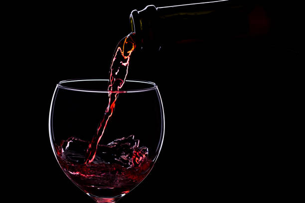 istock Wine glasses with wine bottle on a black background, minimalism, 640352906
