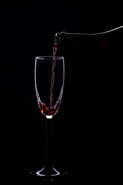 Wine glasses with wine bottle on a black background, minimalism,