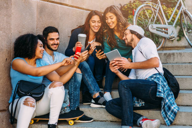 istock Friends browsing the net outdoors 640355392