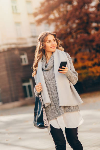 istock Young woman texting outdoors 640355568