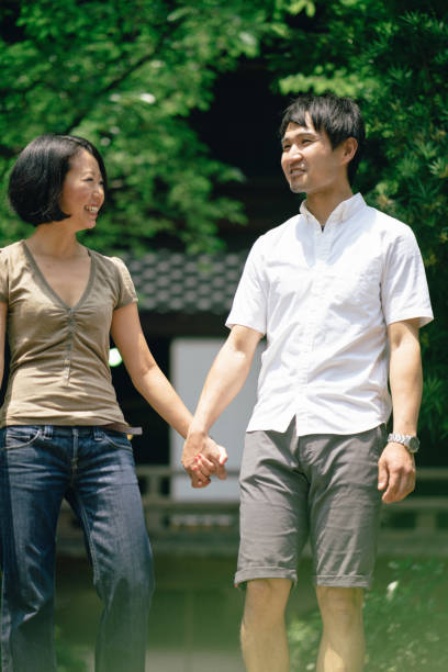 istock Cheerful japanese couple at the temple, front view 640356352