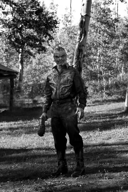 istock Retro Styled Alien Walking Through The Woods With A Gun 640768262