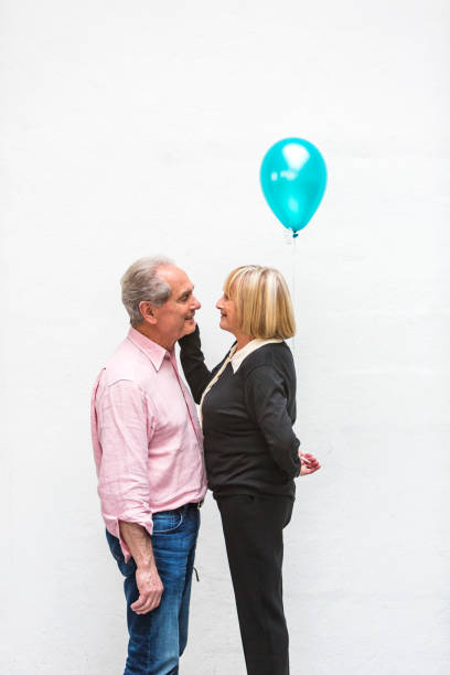 istock Loving Happy Active Senior Couple Playing With Balloons 640783970