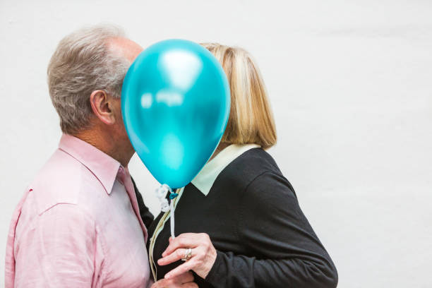istock Loving Happy Active Senior Couple Playing With Balloons 640783980