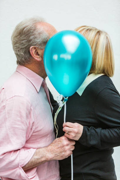 istock Loving Happy Active Senior Couple Playing With Balloons 640783986