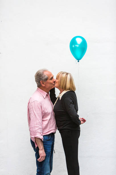 istock Loving Happy Active Senior Couple Playing With Balloons 640783988