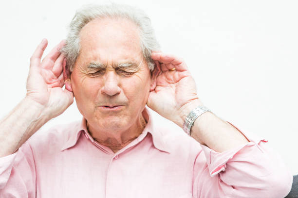 Deaf Senior Shouting to be Heard Deaf senior with hands cupped to ears to help with hearing while shouting old man cupping his ear to hear something stock pictures, royalty-free photos & images