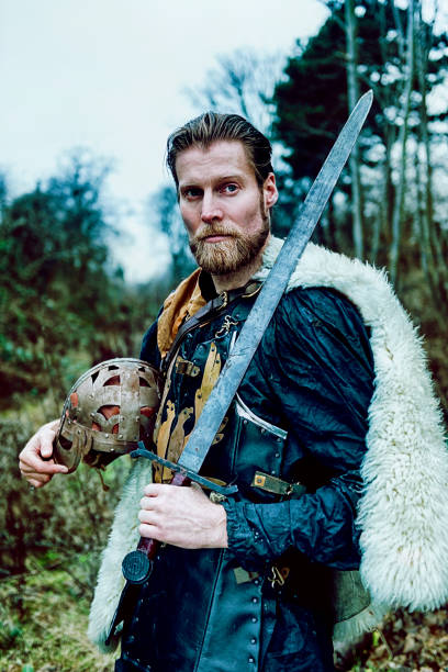 istock Portrait of warrior with beard who holds sword 640831222