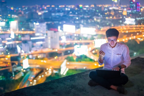 istock Young business man using laptop and tablet cityscape 640831922