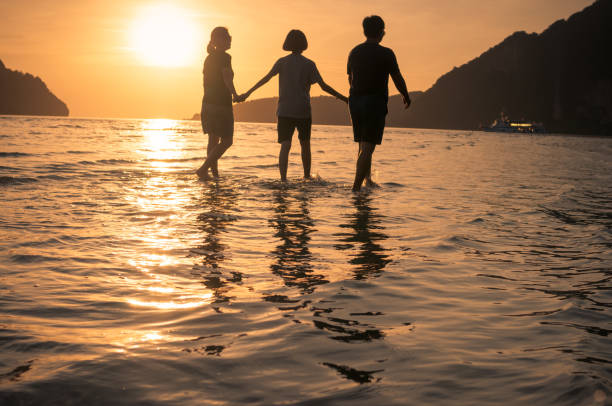 istock happy family walking on the beach 640832946