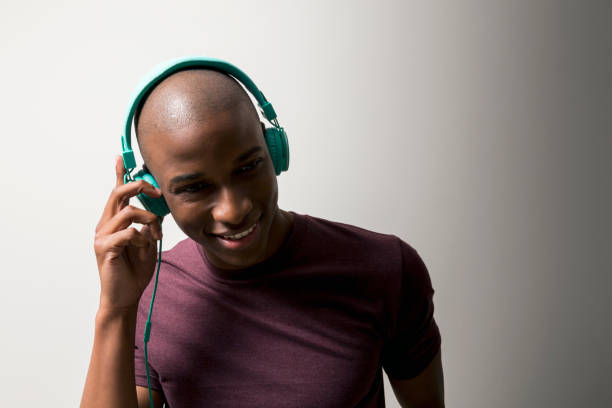 istock Happy man listening music against white background 640834614