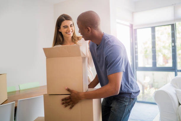istock Happy couple unpacking cardboard boxes at new home 640834660