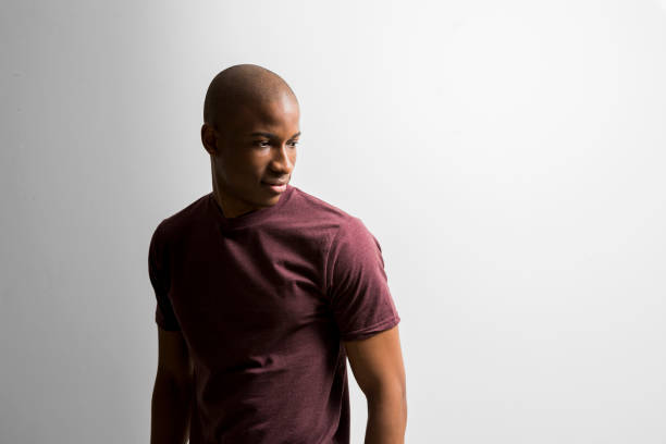 Young man looking away against white background