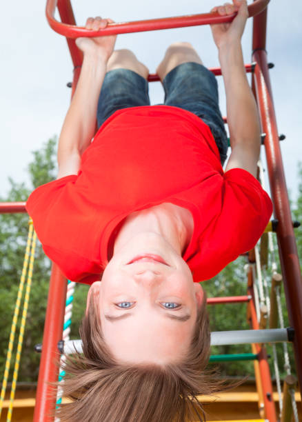 istock Kid hanging from a jungle gym 640835438