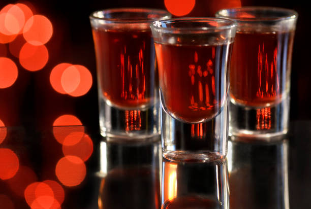 Cocktail Red cocktail in shot glasses glass of bourbon stock pictures, royalty-free photos & images