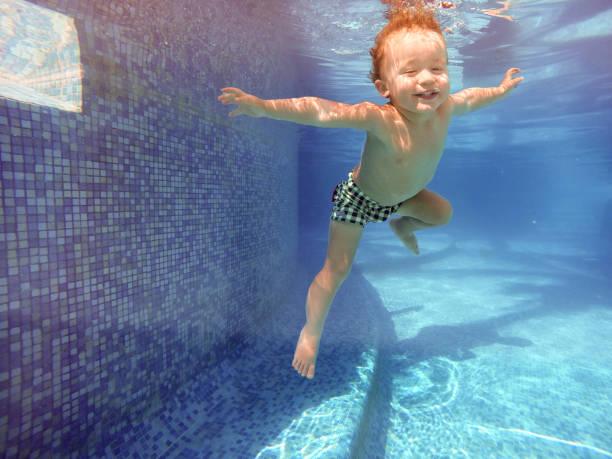 istock Boy swimming underwater 640836750