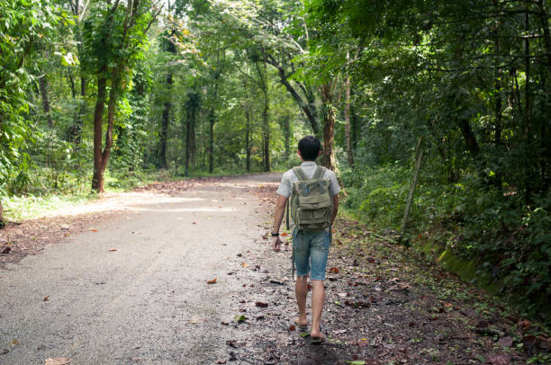 istock Businessman with backpack and laptop and phone at  waterfall  the forest. 640839518