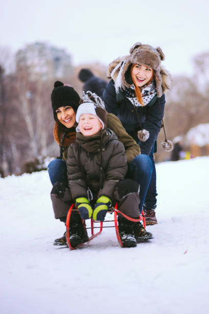 istock Two Young Mothers And Son Bonding On Snow 640871500