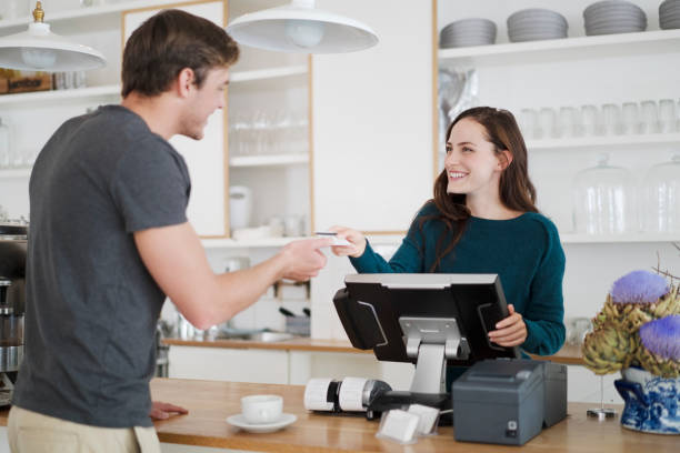 Cashier receiving payment from customer in cafe