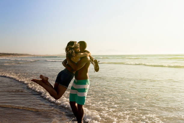 istock Loving man carrying woman on shore at beach 640879494