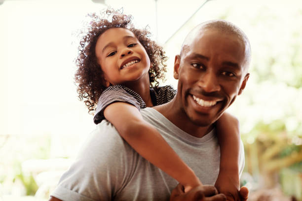 istock Happy father piggybacking son at yard 640881626