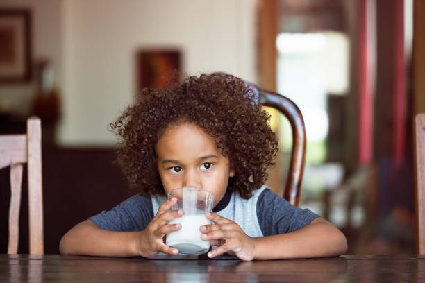 istock Thoughtful boy drinking milk at home 640881868