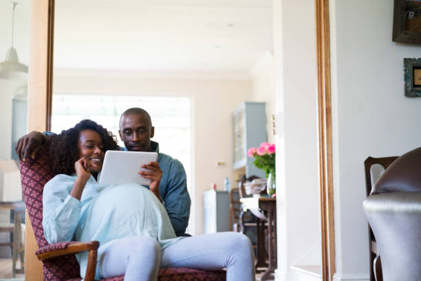 istock Man using digital tablet with pregnant woman 640882006