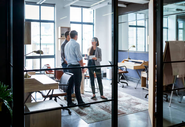 istock Business people having discussion in glass office 640882098