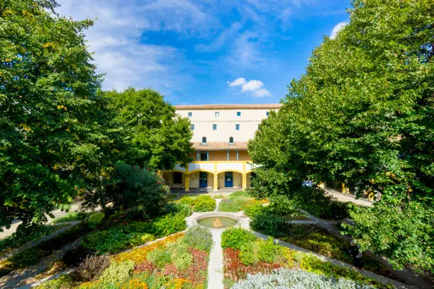 A glimpse at Espace Van Gogh, the old Arles hospital courtyard. The location was named in honor of the artist who stayed in that psychiatric facility, on two occasions, in 1888 and 1889. It is now a public space and the buildings is used for social service offices.