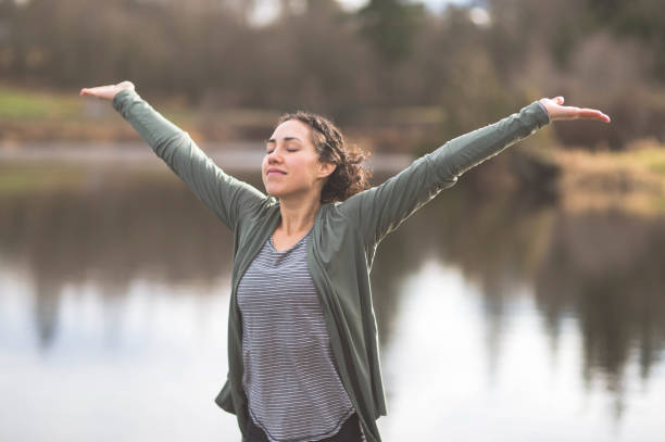istock Young mom doing yoga outside by lake 640900004