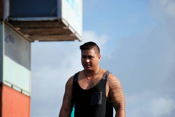 Close-up Of Happy Man In Tanktop With Folded Arms Against White Background