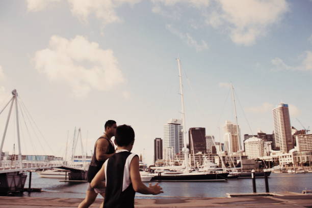istock Pacific Island Man and Boy Plays Rugby against a Cityscape Harbour 640901838