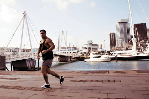 istock Pacific Island Man Runs against a Cityscape Harbour 640901840
