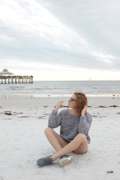 istock Girl is sitting on the beach 640902126