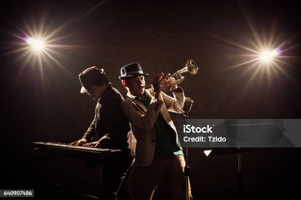 Musical Concept Musicians Playing A Trumpet And Keyboard Stock Photo - Download Image Now