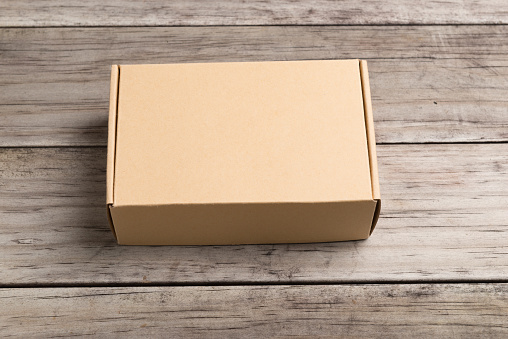 Cardboard box on a  wooden background