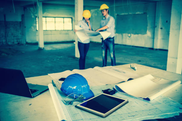 istock Industrial engineer Concept, Engineering equipment on the table at the building site workplace over the couple engineers working 640908632