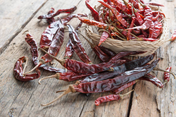 istock Dried chili peppers on wooden background 640908930