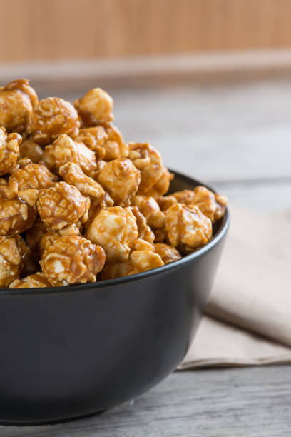 istock Caramel popcorn on wooden background 640911520