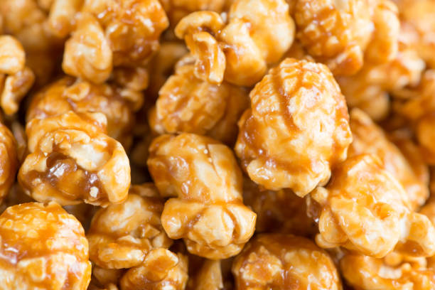 istock Caramel popcorn on wooden background close up 640911784