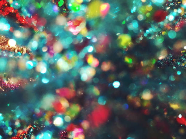 A colorful abstract background with circles from a bokeh effect. The prominent colors are shades of blue, green, pink and red.