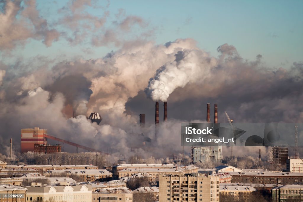 Poor environment in the city. Environmental disaster. Harmful emissions into the environment. Smoke and smog. Pollution of the atmosphere by plants. Exhaust gases. Wind Stock Photo
