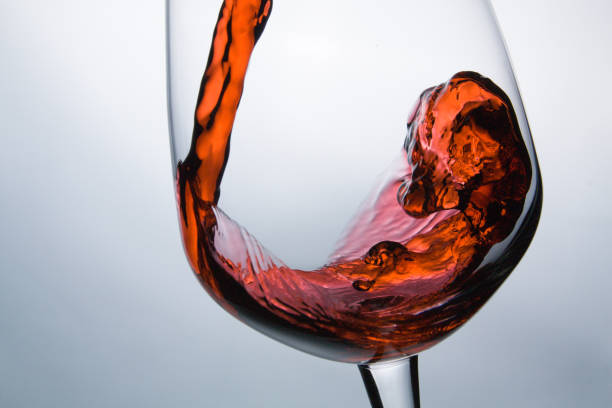 istock wine being pouring into a glass closeup wine splashing splash 640916670