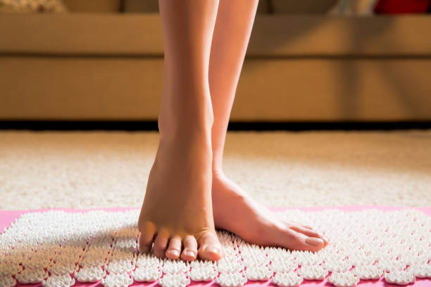 istock Female feet standing on acupressure mat 640918784