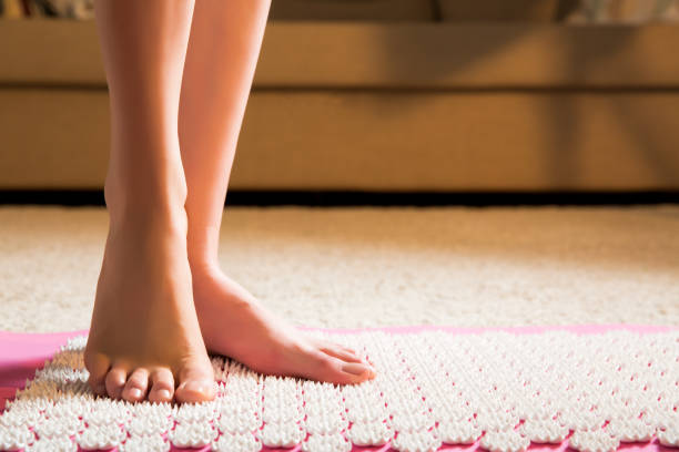istock Female feet standing on acupressure mat 640918792